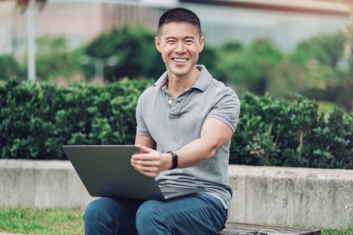 Middle aged Asian man working outdoors