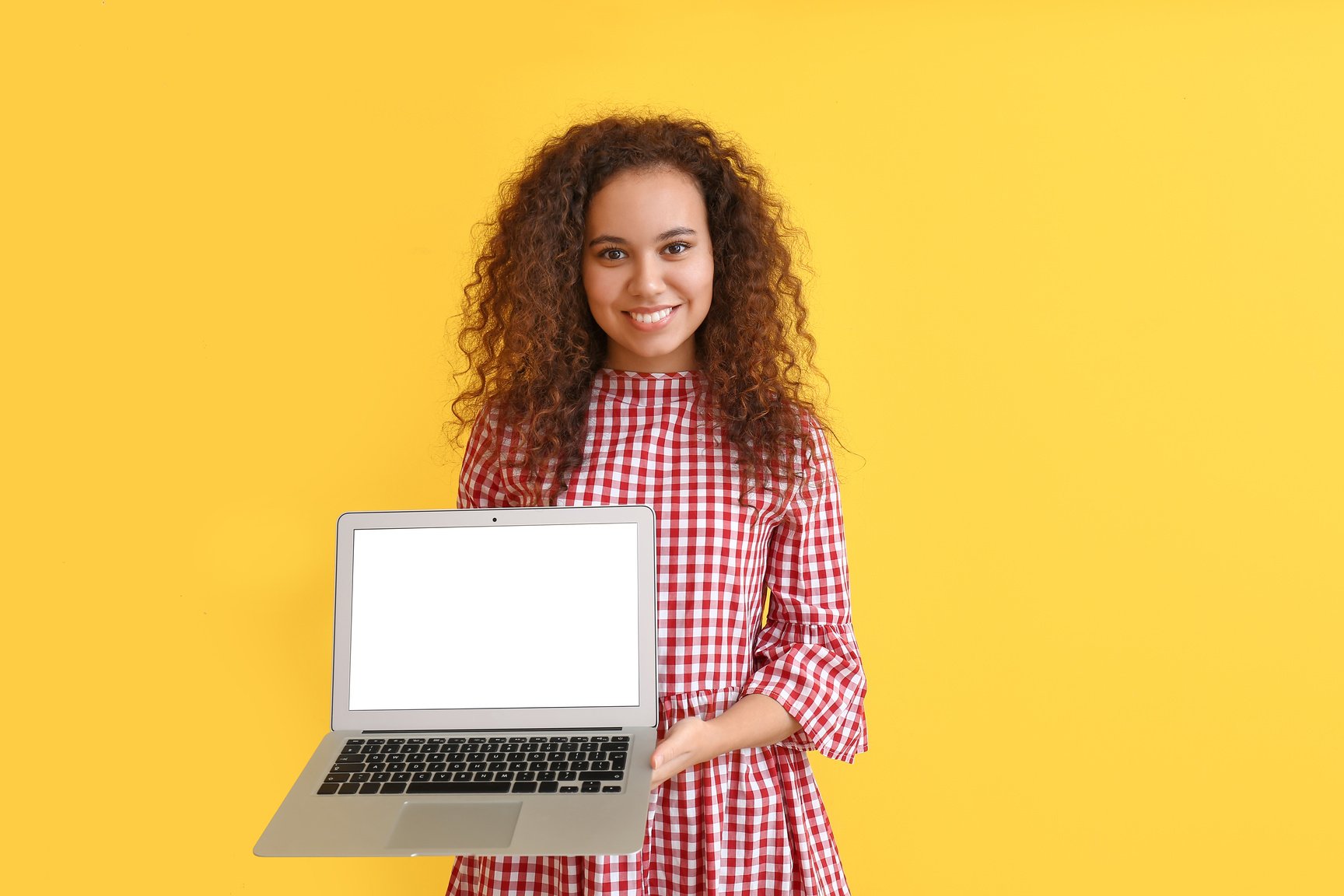 Beautiful Young African-American Woman with Laptop on Color Background